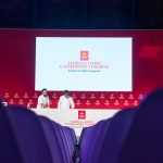 Two chefs practising on stage before an event.